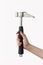 Hand holds rock climbing hammer with black handle and shiny iron tip. The concept of sports activities