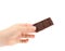 Hand holds tasty morsel of dark chocolate.