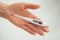A hand holds a thermometer. Fever as a sign of Coronovirus Covid-19