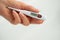 A hand holds a thermometer. Fever as a sign of Coronovirus Covid-19