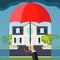 The hand holds an umbrella over the house. The concept of home security.