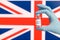 Hand holds vial of vaccine on a british flag
