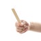 The hand holds wooden spatulas. Close up. Isolated on a white background