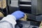 Hand of a human in glove works on conveyor. automatic line for the production of crispy whole grain bread at the factory