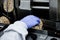 Hand of a human in glove works on conveyor. automatic line for the production of crispy whole grain bread at the factory.