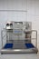 Hand hygiene station with turnstile gate and sanitizer before entering production area. Infection prevention, disinfection,