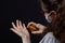 Hand hygiene for viral infections, young girl in an antiviral medical respiratory mask puts on her hands an antiviral, antiseptic