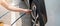 Hand inflating tires of vehicle, checking air pressure and filling air on car wheel at gas station. self service, maintenance and