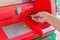 Hand insert credit card to ATM bank cash machine for withdraw mo