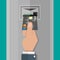Hand inserts a credit debit card into ATM