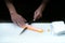 Hand of Japanese chef slicing salmon