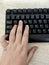 Hand on keyboard with fingers on WASD gaming keys