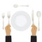 Hand with a knife and fork. Tableware.
