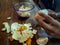 Hand with a knife peeling and slicing the tangerines