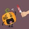 Hand with a knife prepare to cut the funny pumpkin character