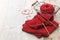 Hand knitted red scarf and heart shaped thread