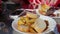 Hand of lady preparing tapas at plate