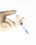 Hand in latex glove hold medicine syringe