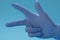 Hand in latex gloves shows on a blue background background