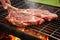 hand laying out t-bone steak on a hot grill grate