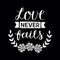 Hand lettering with bible verse Love never fails made with flowers on black background