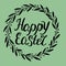 Hand lettering Happy Easter, made in the circle of leaves.