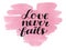 Hand lettering Love never fails made on watercolor background.