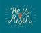 Hand lettering He is risen with a cross on blue background.