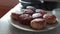 Hand lifts the lid of the pan, hot steam comes from meatballs