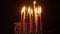 The hand lights a candle on a festive Hanukkah