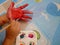 Hand of a little baby being painted with red color - baby handprint / fingerprint painting