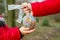 Hand of a little child reaching out to take a globe in plastic bag from an adult so he can take care of the earth for his future.