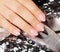 Hand with long artificial black french manicured nails