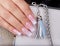 Hand with long artificial manicured nails with ombre gradient design