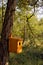 Hand made bird house hanging on a tree trunk