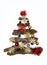 Hand made Christmas tree. Made with tree bark, chistmas balls and fir cones on white background. Minimal holiday and celebration