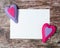 Hand made felt colorful hearts white paper on wooden background