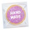 Hand made Frosted sugar Italian Freshly baked cookie in transparent plastic package with violet frosting and colorful sprinkles. B