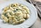Hand made gnocchi and fork on a wood background
