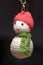 Hand made key ring snowman knitted doll wearing a red hat and green scarf