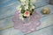 Hand made macrame lace napkin lies on a wooden windowsill.