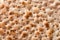 Hand-made matzah on Pesach holiday. Top view of flatbread matzo, macro, background