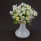 Hand made polymer clay bouquet in a white vase on a dark background