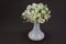 Hand made polymer clay bouquet in a white vase on a dark background