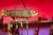 Hand made wooden carving engraved fish figure artwork on wood plank with suspended green beads on string.tribal artwork. textured