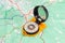 Hand magnetic compass on a tourist topographical map