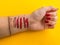 Hand of makeup artist with bright red manicure. applying makeup to the skin and the soiled hand. cosmetic swatches are applied on