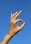 hand making OM yoga symbol with forefinger and thumb finger touc