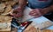 hand of a male craftsman making wooden pictures