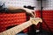 Hand of male musician tuning guitar in studio